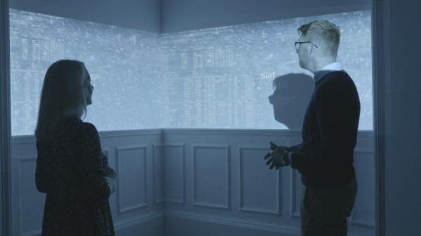 A man and a woman looking at projected art